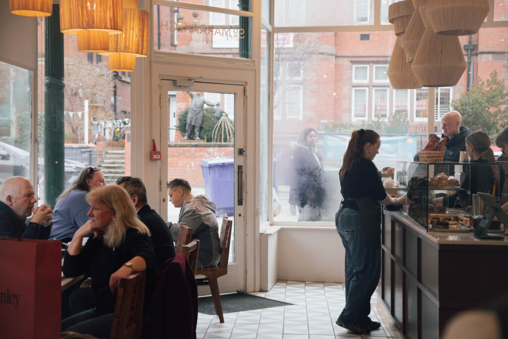 Customers dining inside cozy cafe.